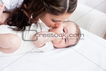 Caucasian young mother taking care of her adorable baby