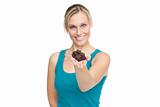 healthy woman showing chocolate bar to the camera against a whit