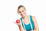 joyful woman with an apple and a measuring tape