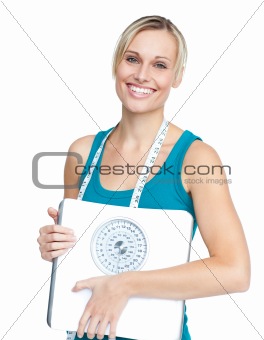 Caucasian young woman holding a weight scale