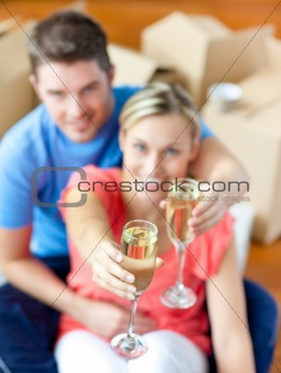 Young couple sitting on the floor in flat
