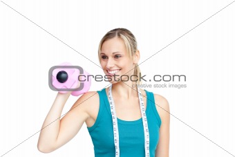Smiling young woman holding a dumbbell