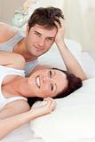 Radiant caucasian couple lying on bed
