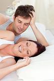 Glowing caucasian couple lying on bed