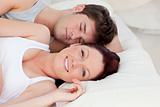 Lovely young couple resting in bed together