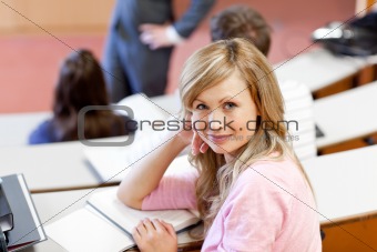 Serious students listening to their teacher at university