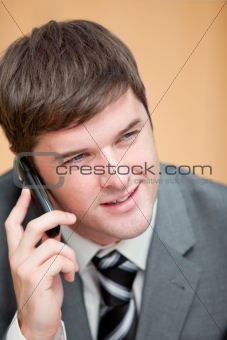 Charismatic businessman talking on phone in his office