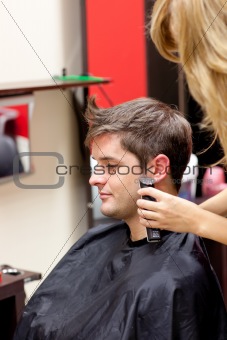 Young caucasian man being shaved