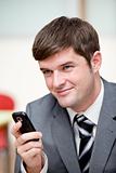 Portrait of an assertive businessman sending a text message with