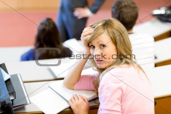Portrait of a bored female student during a university lesson
