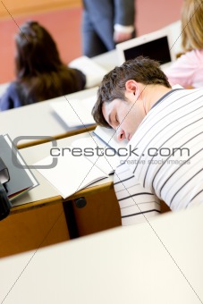 Asleep male student during an university lesson