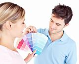 Enamored couple choosing color for a room