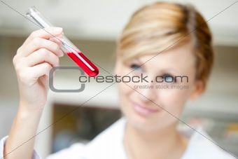 Close-up of a female scientist looking at a test tube