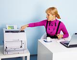 Young woman - secretary prints out a document