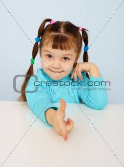 Funny little girl shows a finger