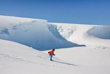 Man moves on skis. Glacier in background. Antarctica
