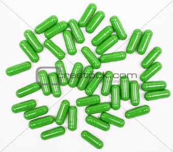 Green pills on white background 