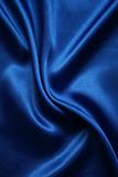 Smooth elegant dark blue silk as background 