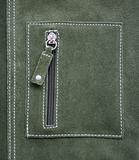 Pocket on green leather texture as background 