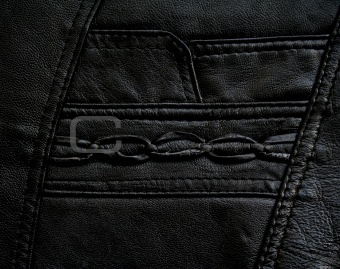 Pocket on the black leather texture 