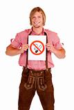 Smiling Bavarian man in lederhose holds non-smoking-rule sign