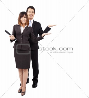 young smiling businesswoman and businessman. with their hand outstretched and presenting something