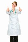 Smiling medical doctor woman showing thumbs up gesture
