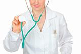 Medical doctor holding up stethoscope. Close-up.
