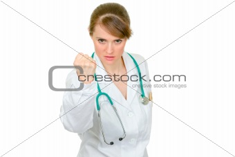 Angry medical doctor woman threaten with fist
