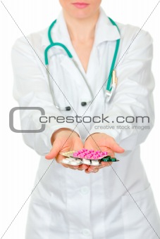 Doctors hand holding packs of pills. Close-up.

