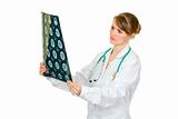 Concentrated medical doctor woman holding tomography in hand
