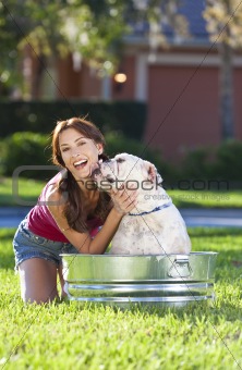 Beautiful Woman Washing Her pet Dog In A Tub