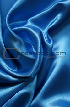 Smooth elegant dark blue silk as background 