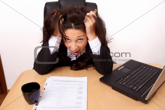 Young woman stressed at work