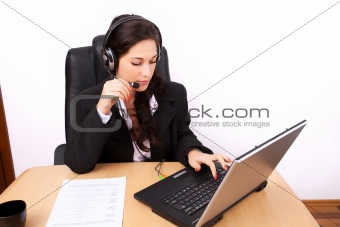 Young woman with headphones assisting online