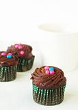 Miniature chocolate cupcakes and coffee
