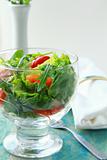 spring salad with mixed salad and cherry tomatoes in a glass bowl