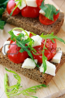 sandwich with mozzarella and tomatoes on rye bread of Italian style