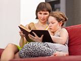Girl and mom reading book