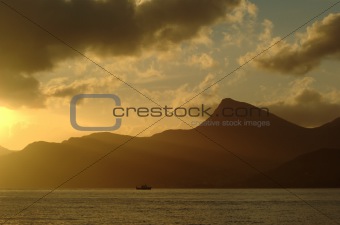 Boat on Sea at Sunset with Sunrays