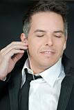 Confident Businessman Puts In Headphones