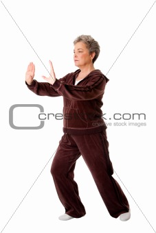 Senior woman doing Tai Chi Yoga exercise