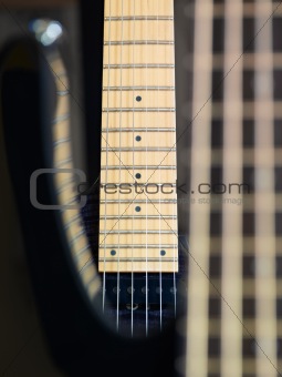 detail of electric guitar cords and frets