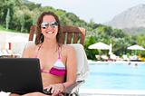 woman with laptop near pool