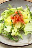 potato salad with smoked salmon and arugula on a plate
