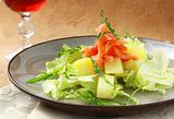 potato salad with smoked salmon and arugula on a plate