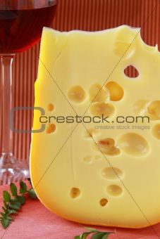 large piece of cheese varieties Maasdam  on cutting board