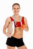 Sports woman holding an apple and carrying a weight scale