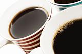 Close ups of mugs of black coffee