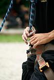Climber clipping carabiner into harness